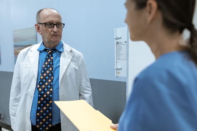 Healthcare professionals talking together in a clinical setting